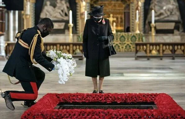 Queen Elizabeth wore a black mask and Jardine diamond star brooch.  National Service of Remembrance at The Cenotaph