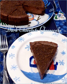 Dark Chocolate Cheesecake, a chocolate crust is filled with a creamy dark chocolate cheesecake mixture, baked, then sprinkled with a little chocolate crumble. | Recipe developed by www.BakingInATornado.com | #recipe #chocolate