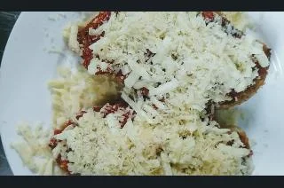 Chicken breasts topped with mozzarella and parmesan cheese for healthy chicken parmesan recipe
