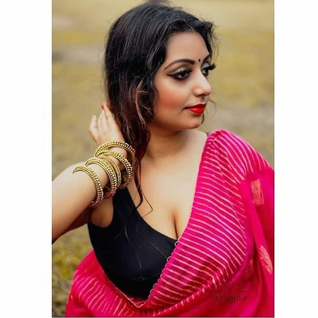 Rupsa Saha Chowdhury poses in a crimson saree with a black sleeveless blouse Navel Queens