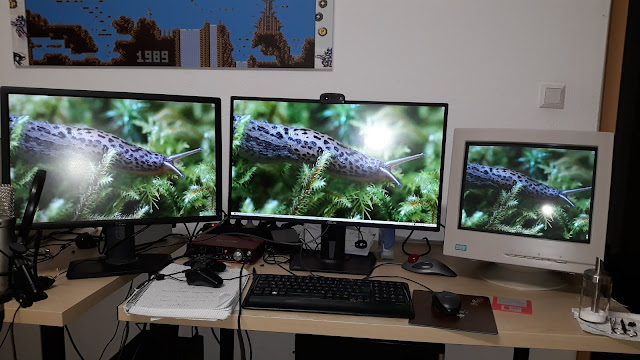 3 monitors in a row. 2 TFTs and 1 CRT.