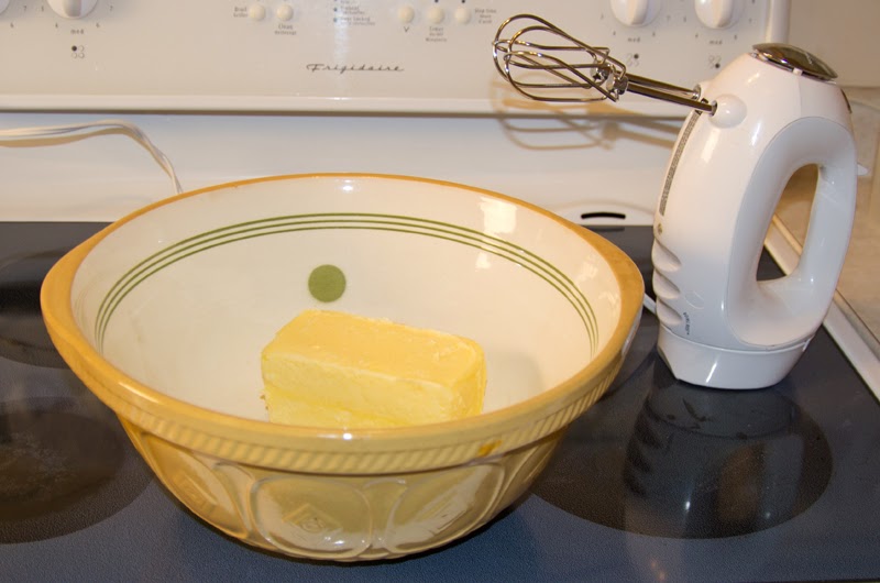 Large vintage ceramic mixing bowl with a pound of butter and mix-master.