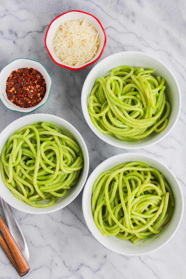 Looking for an easy dinner recipe? This Bucatini with Spinach Pesto is the best! Fresh pesto is tossed with hot cooked pasta for a simple yet flavor packed meal!