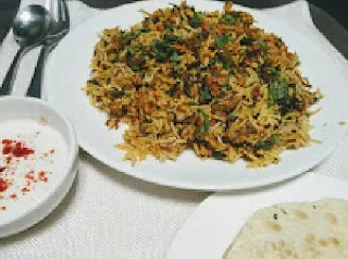 Serving veg biryani with raita and papad for veg biryani recipe in cooker