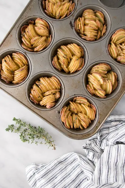 Top view of sliced potatoes in a muffin tin.