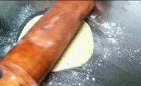 Rolling dough ball with a roller pin for pakwan recipe