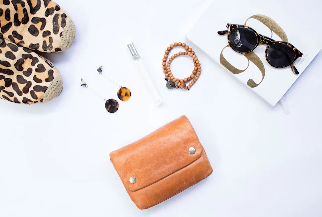 flatlay with leopard print shoes, clutch bag and jewelry.