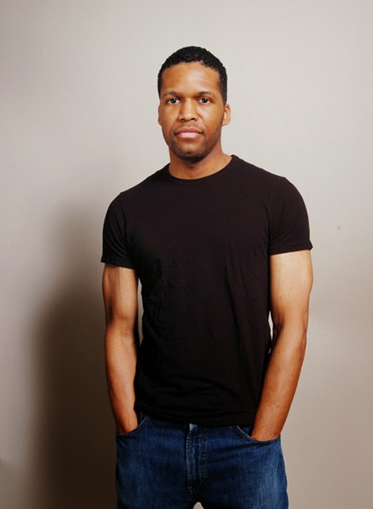 headshot of a black actor in washington dc wearing a dark t-shirt standing