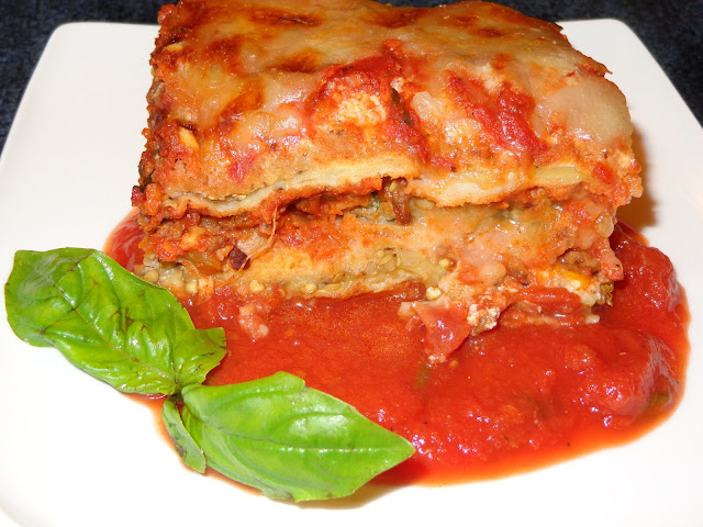 PORTIONS: 12 INGREDIENTS 1 Large breaded eggplant in slices 6 breaded zucchinis in slices Meat sauce Tomato sauce 1 lb. ricotta cheese 1½ lb. shredded mozzarella cheese ½ cup grated roman, parmesan or pecorino cheese INGREDIENTS TO BREAD THE VEGETABLES 1 large eggplant cut in thin slices 6 zucchinis cut in thin slices 1 cup all-purpose flour  4 beaten eggs 2 cups panko bread crumbs 2 cups regular bread crumbs METHOD Season the flour and eggs with a bit of salt. Mix panko and regular bread crumbs. Dip the eggplant and zucchini slices in flour, eggs, breadcrumbs and place them in a baking sheet pan. Preheat the oven in low broil. Brown the eggplant and zucchini. MEAT SAUCE 14 oz. / 397g ground beef 1 tbsp. olive oil 3 garlic cloves, minced 1 cup small diced onions ½ cup small diced carrots ½ cup small diced celery 1 tsp. salt ¼ tsp. pepper 1 tbsp. capers 1 tbsp. pitted green olives, diced 1 tbsp. fresh basil leaves cut in thin strips ½ tbsp. fresh oregano leaves 5 cups chunky tomato sauce METHOD Heat a frying pan with olive oil and brown the ground beef. Add garlic, onions and slightly brown them. Add the carrots, celery, salt, pepper and cook for a couple minutes. Incorporate the capers, olives, basil leaves and tomato sauce. Mix and heat up.  RICOTTA CHEESE ¼ tsp. salt ¼ tsp. onion powder ¼ tsp. garlic powder 1 tbsp. chopped fresh basil leaves METHOD Mix the ricotta cheese with the rest of the ingredients. ASSEMBLING THE LASAGNA Spread a layer of tomato sauce in a baking dish Using a spatula spread the ricotta cheese along the eggplant and zucchini baked slices. Place a layer of eggplant on top the tomato sauce. Add a thin layer of meat sauce and on top shredded mozzarella with grated cheese. Place on top a layer of zucchini, meat sauce, shredded mozzarella and grated cheese. Finish the lasagna with another layer of baked vegetables, meat sauce, shredded mozzarella and grated cheese. Bake it a 400°F / 204°C until the top is golden brown. Let it rest for a few minutes before cutting.