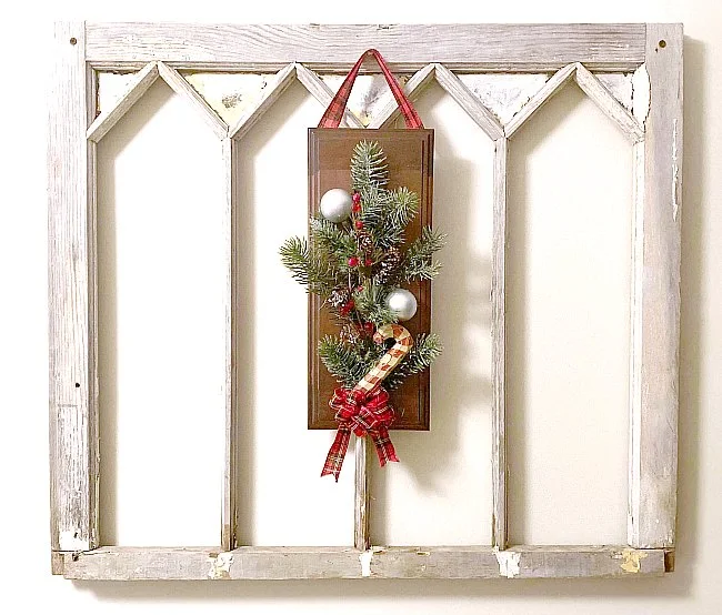 Cabinet door wreath on a vintage window