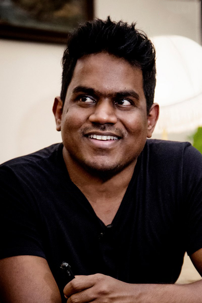 Yuvan Shankar Raja in black tshirt smiling