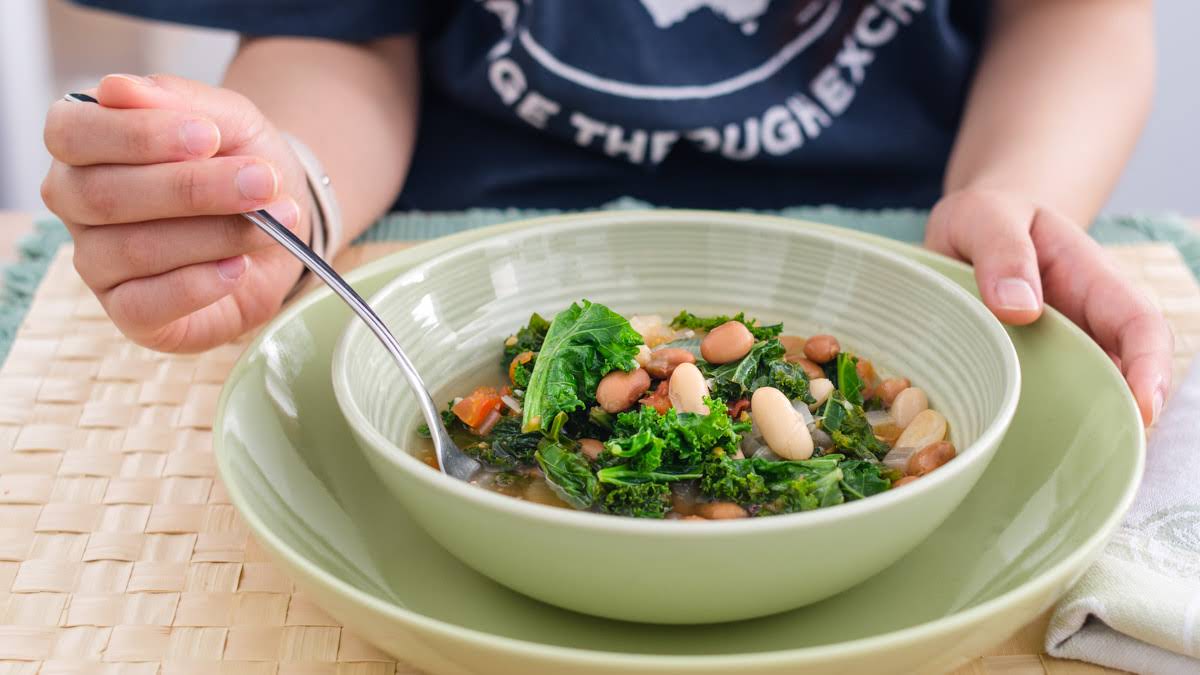 A bowl of Kale Tomato Beans and Fennel Soup photo