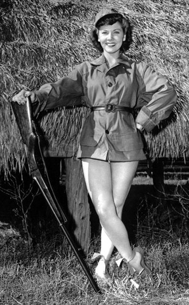 Actress Grace McDonald with shotgun and no pants