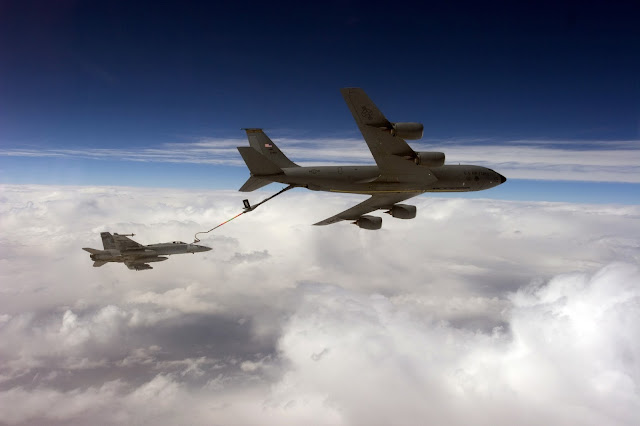 An F/A-18C Hornet receives fuel from an Air Force KC-135 Stratotanker