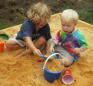 TWO KIDS PLAYING IN A SANDBOX