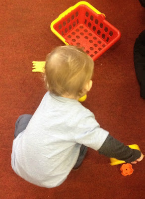 Toddler playing with toy saucepan and fries