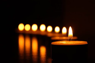 Image is an illustration of lit candles with text that states: "Disability Day of Mourning: remembering people with disabilities murdered by their families." Photo credit: Hyde Park Art