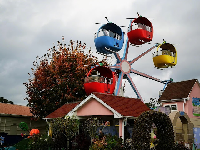 Image of the Helicopter ride at Peppa Pig World featuring different brightly coloured helicopters arranged on a ferris wheel ride.
