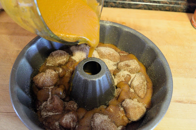 The rest of the puree mixture being added to the bundt pan. 