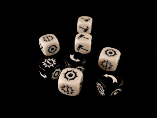 The custom attack and defence dice from Warhammer Underworlds: Shadespire.