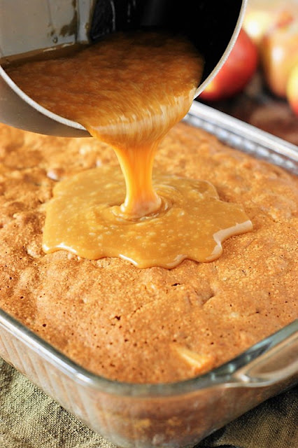 Pouring Boiled Caramel Topping on Old-Fashioned Apple Cake Image