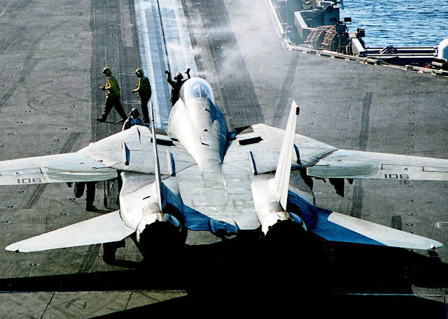 Flight Deck Director guides an F-14D “Tomcat”  onto catapult one for its next catapult launch.