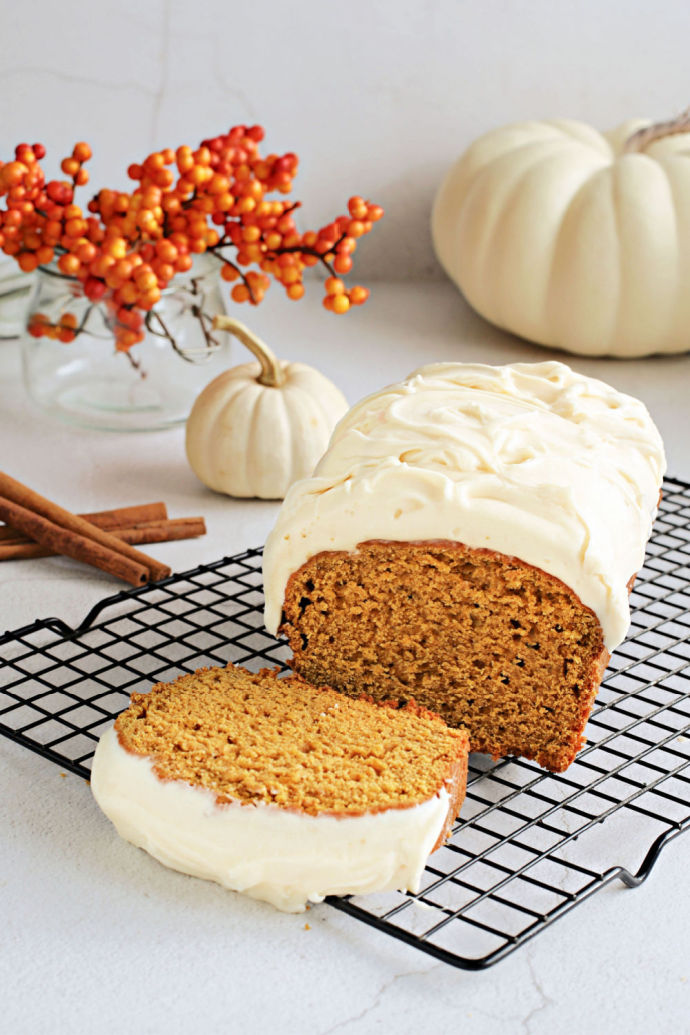 Recipe for a fluffy, flavorful pumpkin loaf cake topped with salted caramel cream cheese frosting.