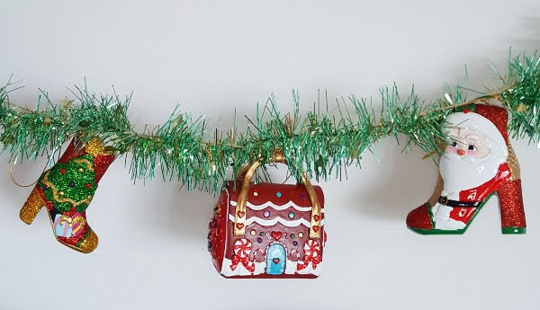 row of Christmas shoe and bag baubles on tinsel string