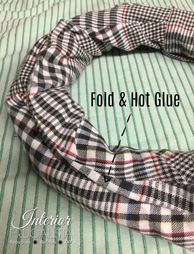 How to make an easy fall wreath with recycled flannel shirt sleeves and dollar store fall floral picks. Even the shirt collar is a wreath hanger!