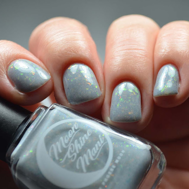 grey nail polish with flakies low light swatch
