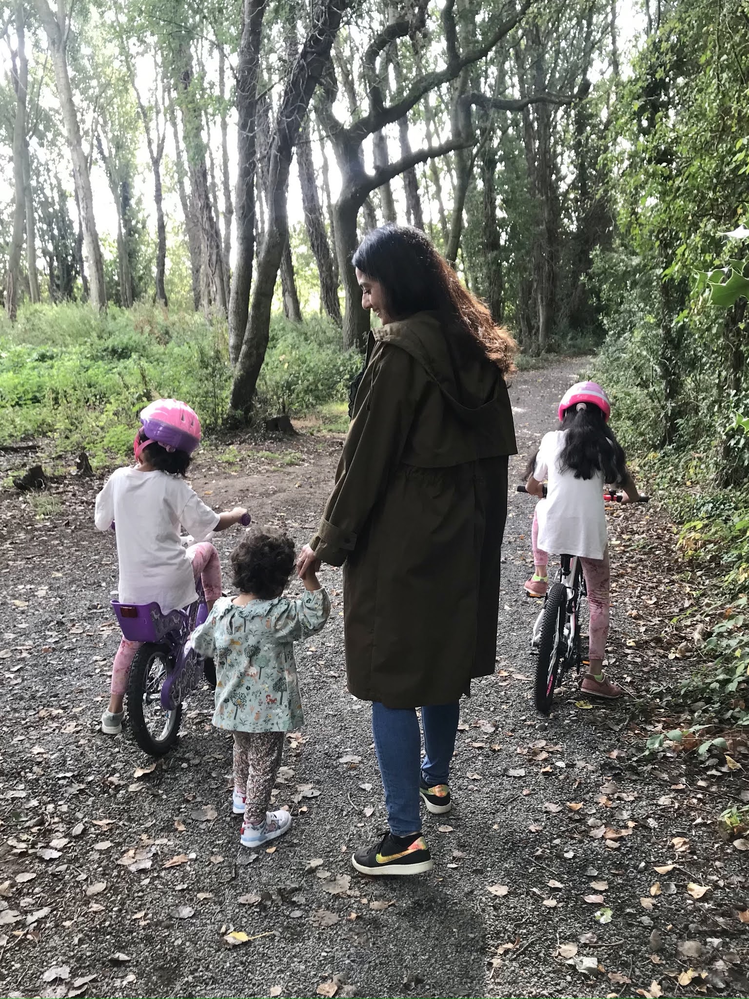 amina walking with her toddler in the woods