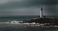 Lighthouse in storm Photo by Daniel Gregoire on Unsplash