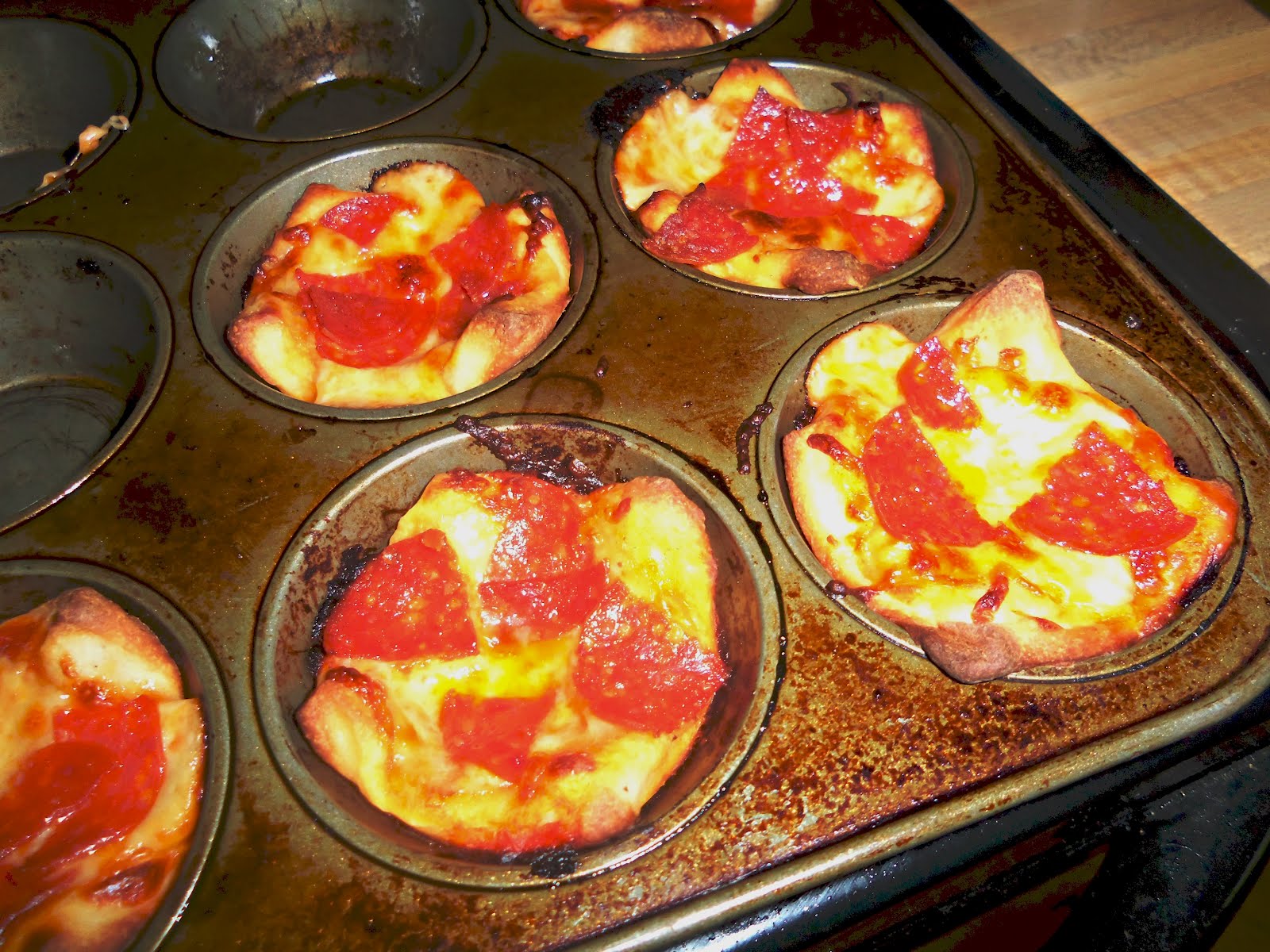 So I saw this neat thing on Pinterest... Muffin Tin Pizzas