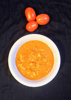 Serving paneer makhani in a bowl