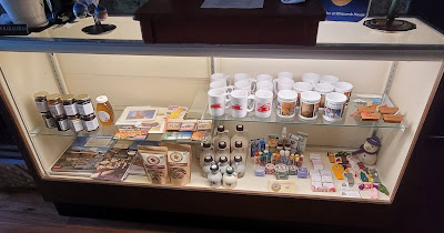 Gift shop cabinet at the inn with mugs, maple syrup, books, soap, and many more locally made products