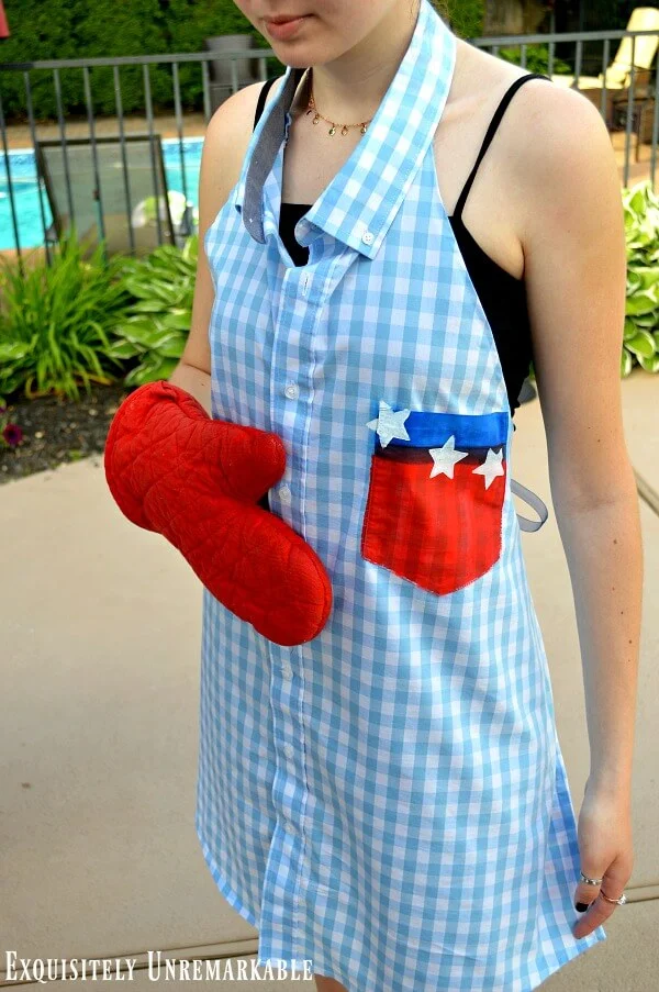 Patriotic Gingham Shirt Apron on model holding an oven mitt