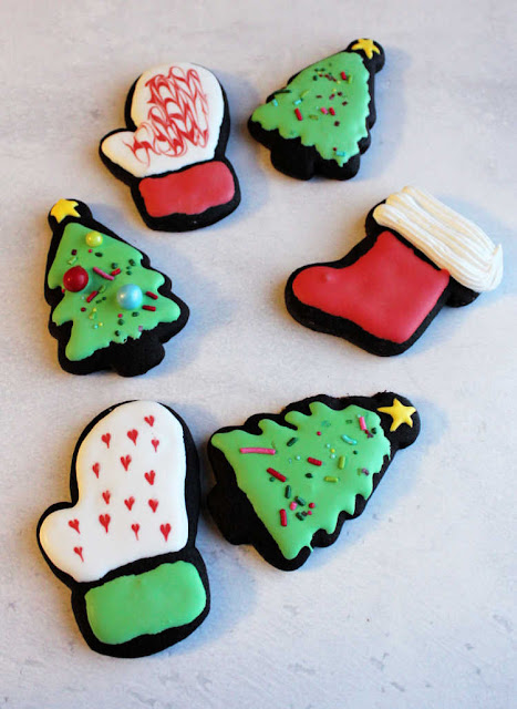 black chocolate christmas cookies decorated dark chocolate cookies cut into Christmas shapes and decorated with royal icing