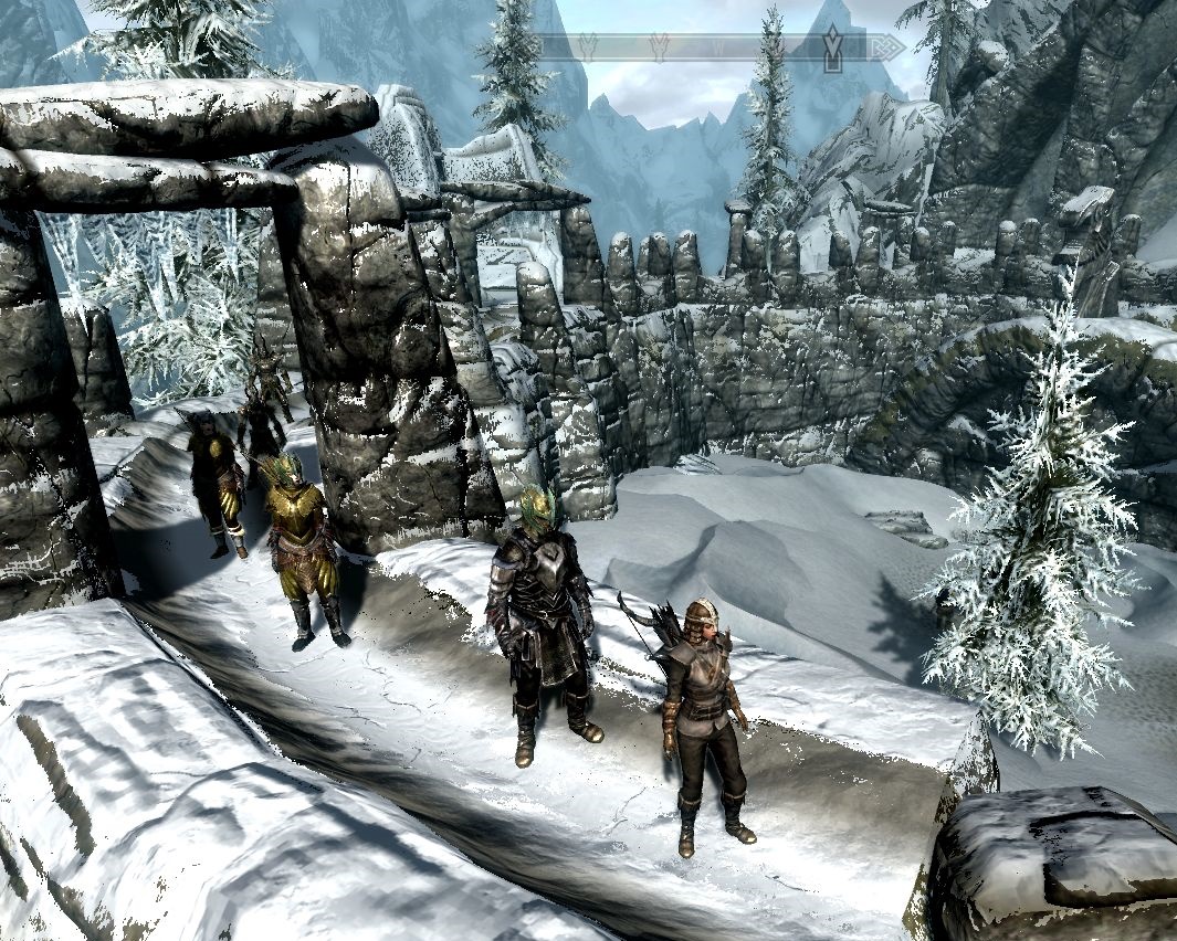 Laura and followers stand on massive stone ramparts, much snow everywhere