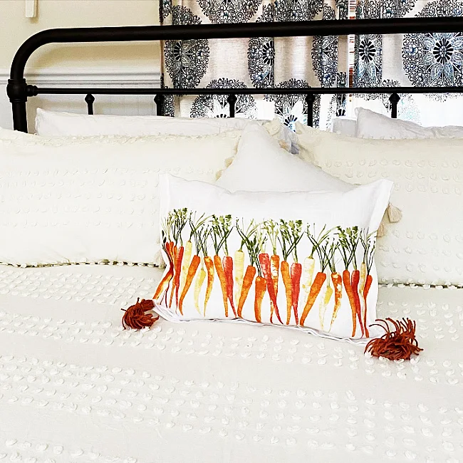 carrot pillow on a bed