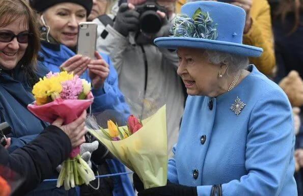 Queen Elizabeth wears her Canadian snowflake brooch. This Sapphire brooch was given to the Queen on behalf of the Canadian people