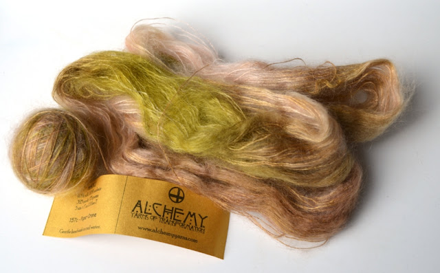 Silk mohair half in a ball and half a hank untwisted in light browns, fawns and muted greens.