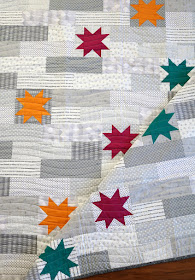 Stellar quilt pattern found in the Fresh Fat Quarter Quilts book by Andy Knowlton of A Bright Corner - a modern baby quilt with a low volume background