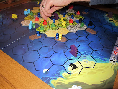 Survive: Escape From Atlantis - The board with explorers on boats and and whales, sharks and sea serpents in the surrounding waters