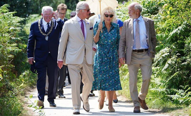 The Duchess wore a hawaiian summery print turquoise blue shirt dress. Prince Charles and Camilla met schoolchildren in St Mary