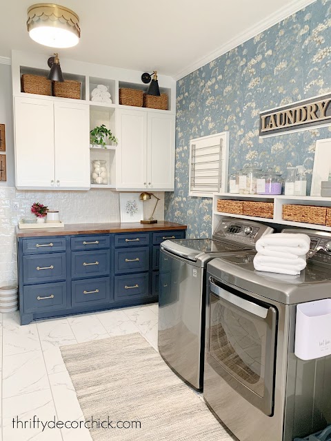 Laundry room with blue white cabinets for storage