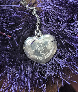 Silver Heart Pendant Necklace on Purple Fun Fur Background