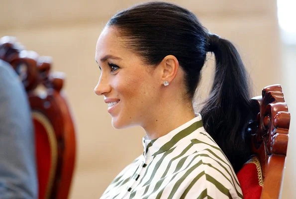 Meghan Markle wore Martin Grant Striped Shirt Dress from Spring Summer 2019 Collection, Prada Biblioteque clutch, Birks Quartz silver earrings.