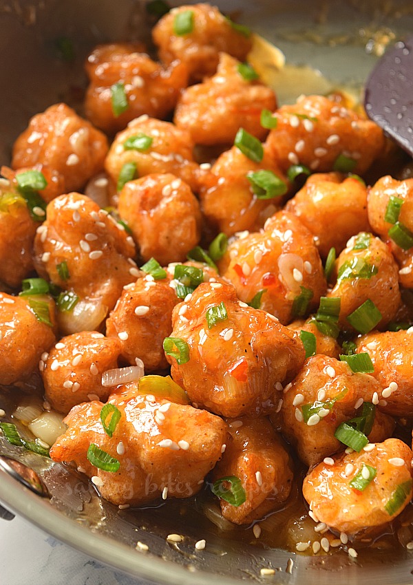 a pan with thai sweet chili chicken topped with sesame seeds