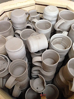 Bisque kiln full of Penland Auction Mugs by Lori Buff