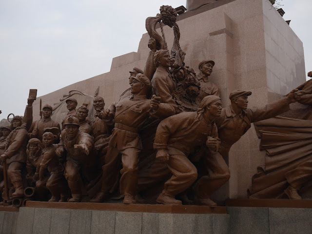 figures surrounding the Mao Zedong statue in Shenyang, China